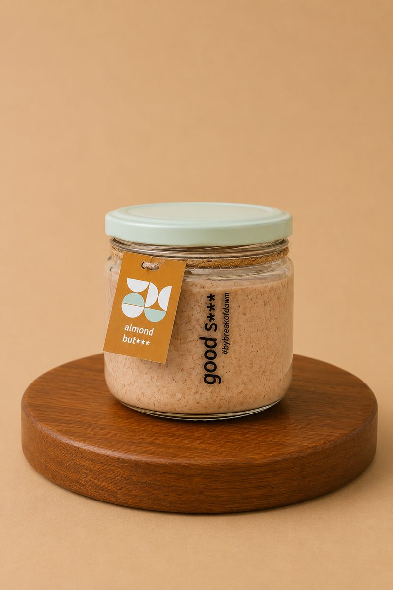 A jar of Break of Dawn almond butter, stone-ground with 29.5 g protein per 100 g